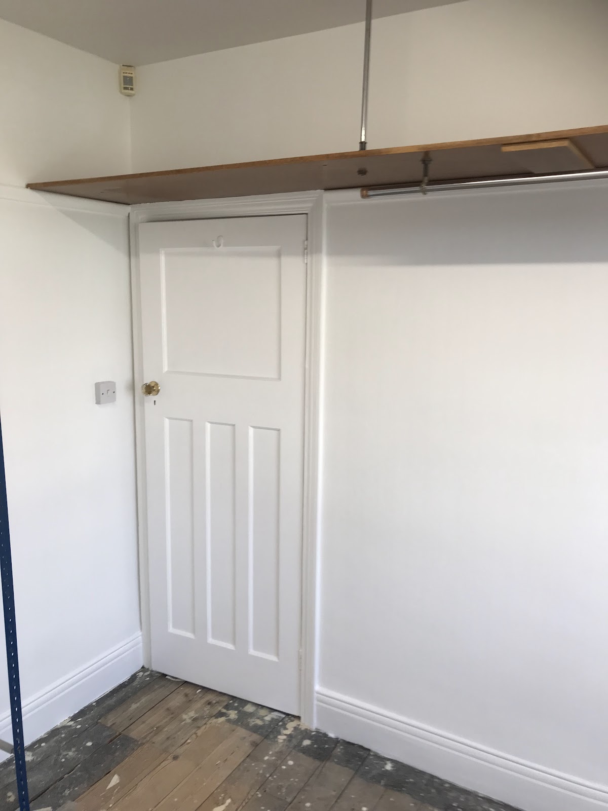 Freshly painted white room with panelled door and new skirting, Byker
